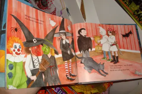 Dzieci w strojach na Halloween, w tym czarownice i klaun. Nasz dyrektor jest wampirem, który wręcza nagrodę za najlepszy kostium.